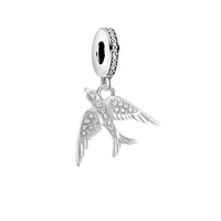 Sterling silver swallow charm adorned with sparkling stones by Planet Charms.
