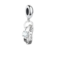 Silver charm with interlocking rings.