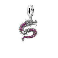 Silver dragon charm with pink stones.