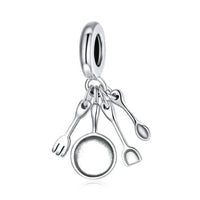 Silver cooking utensil charm.