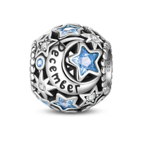 Silver charm with blue stars and ’December’ inscription.