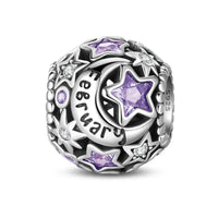 Silver charm with purple stars and moon.