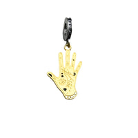 Gold hand-shaped charm with mystical symbols.