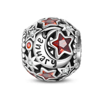 Silver charm with red stars and ’January’ inscription.