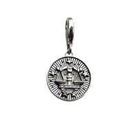 Silver-colored scales of justice pendant.