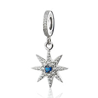 Silver starburst charm with blue center stone.