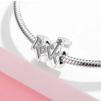 Silver ’Rock’ charm.