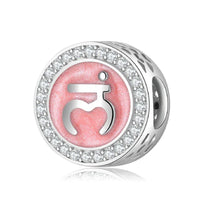 Silver charm with pink symbol and rhinestone border.