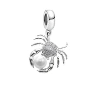 Crab-shaped charm with pearl.
