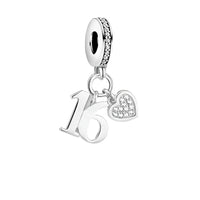 Silver charm with ’16’’ and heart.