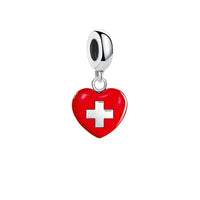 Red heart charm with white cross.