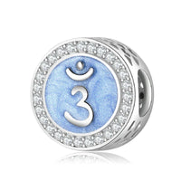 Blue chakra charm with crystal accents.