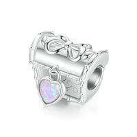 Silver treasure chest charm with heart pendant.