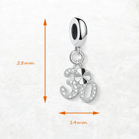 Silver charm with ’30’’ and clover design.