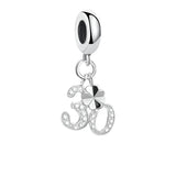 Silver charm with number 30 and clover.