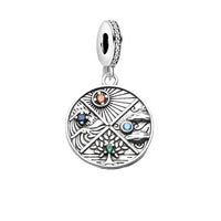 Silver charm with elemental symbols.