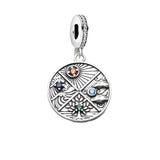 Silver charm with elemental symbols.