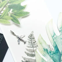 Silver airplane charm.