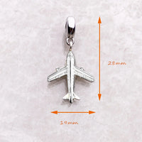 Silver airplane charm.