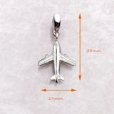 Silver airplane charm.