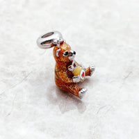 Brown bear charm with honey pot.