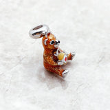 Brown bear charm with honey pot.