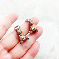 Two bear-shaped charm pendants.