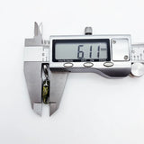 Digital caliper measuring a seahorse pendant.