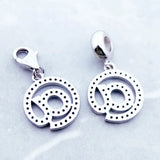 Silver ’@’ symbol charms.