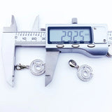Digital caliper measuring a silver charm.