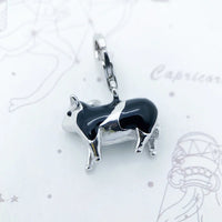 Black and silver cow charm.