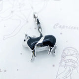 Black and silver cow charm.