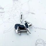 Silver and black cow charm.