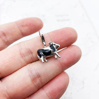 Black and white cow charm.