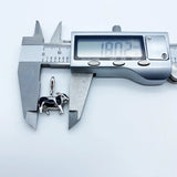 Cow pendant being measured.
