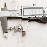 Silver star charm being measured.