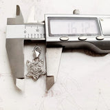 Silver fox pendant being measured.