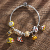 Silver charm bracelet with colorful animal charms.