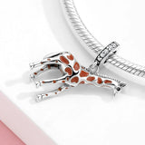 Giraffe charm with brown spots.