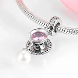 Silver charm bracelet with teacup pendant.