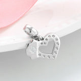 Silver heart and nurse cap charm.