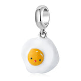 Cartoonish fried egg charm.
