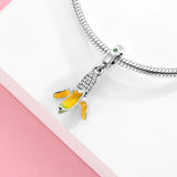 Banana charm with silver accents.