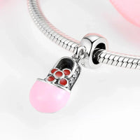 Pink baby shoe charm.