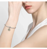 Silver charm bracelet.
