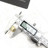 Golden nugget measured by calipers.