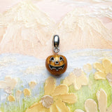 Pumpkin charm with silver bail.