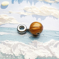 Golden pumpkin charm.