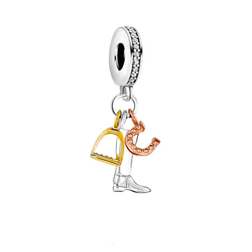 Silver charm with gold stirrup, rose gold horseshoe, and silver boot.