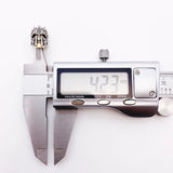 Silver skull bead measured by calipers.
